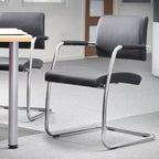 Office chairs with metal frames around a table in an office setting