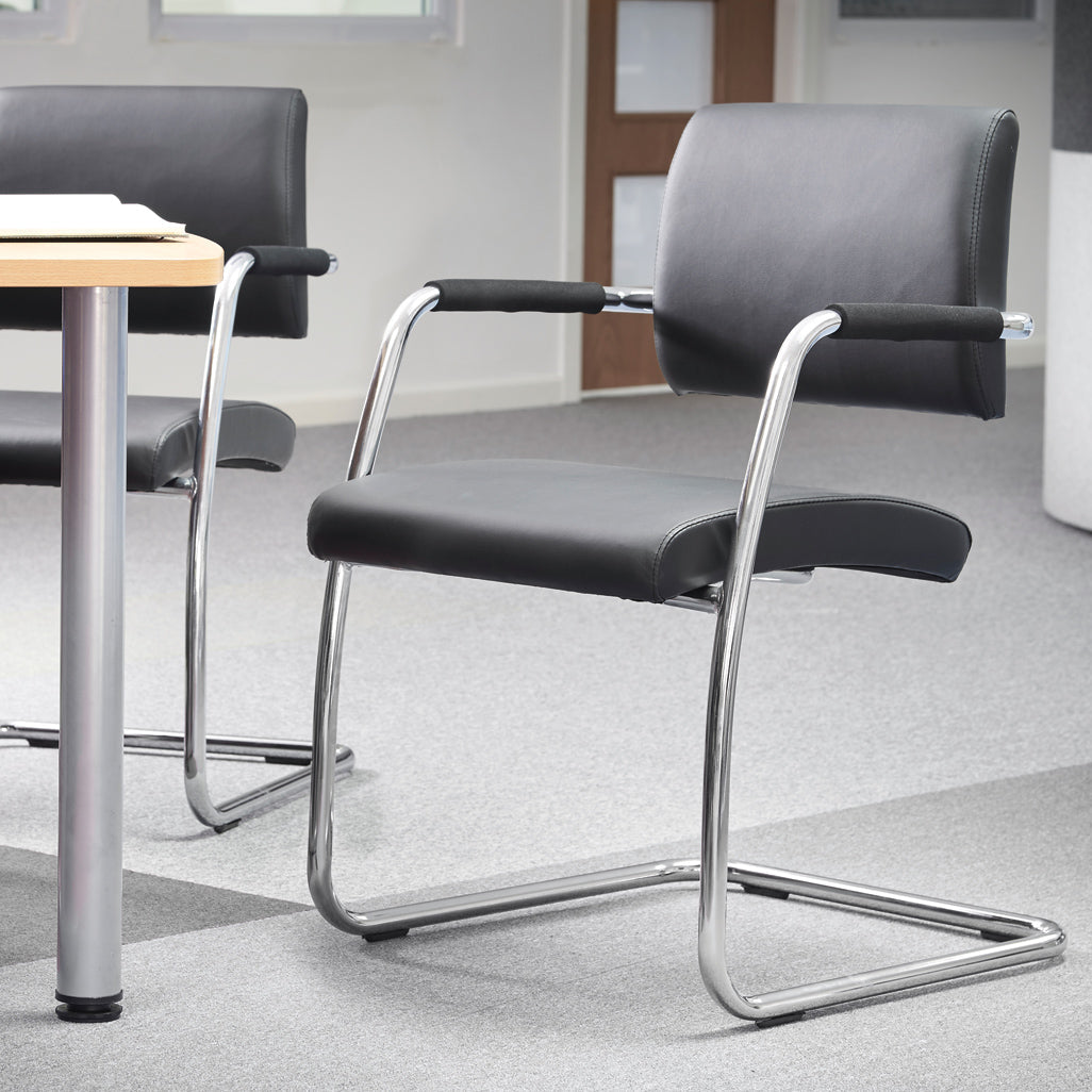 Office chairs with metal frames around a table in an office setting