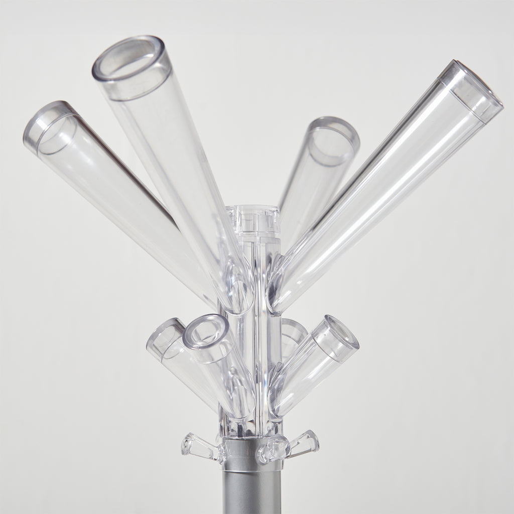 Clear acrylic coat rack with multiple angled cylindrical hooks on a silver metal stand, photographed against a light gray background.