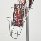 Magazine stand with a 'Vogue' magazine on a white background