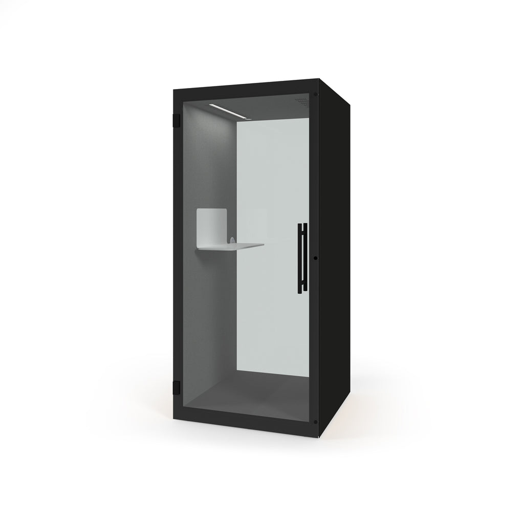 A modern black privacy booth with a glass door, featuring a built-in white shelf and a vertical black handle, shown on a plain white background.