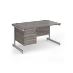 Rectangular desk with grey wood-effect top and matching 3-drawer pedestal, white metal frame, shown on a white background