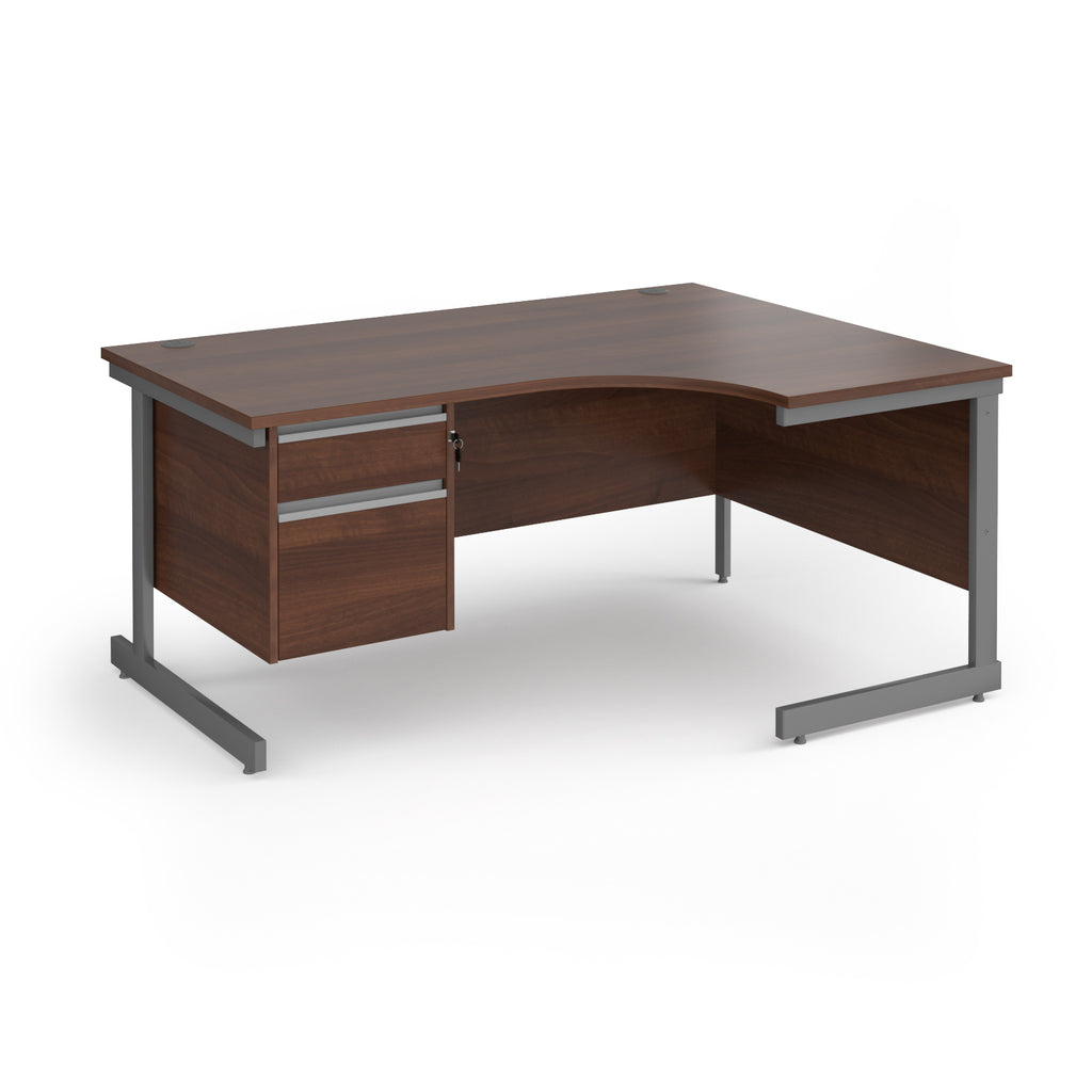 Corner office desk with a dark brown wood grain finish and a grey metal frame, featuring two drawers on the left with silver handles.
