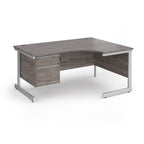 Corner office desk with a grey wood-grain finish and a white metal frame, featuring a two-drawer pedestal on the left side.