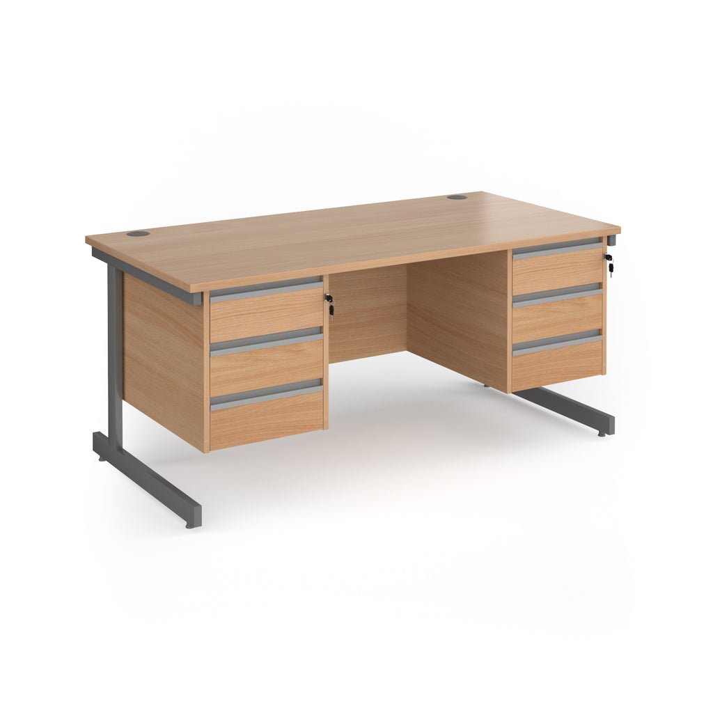 A modern office desk with a light beech wood grain finish and dark grey metal legs, featuring three drawers on the left and three drawers on the right.