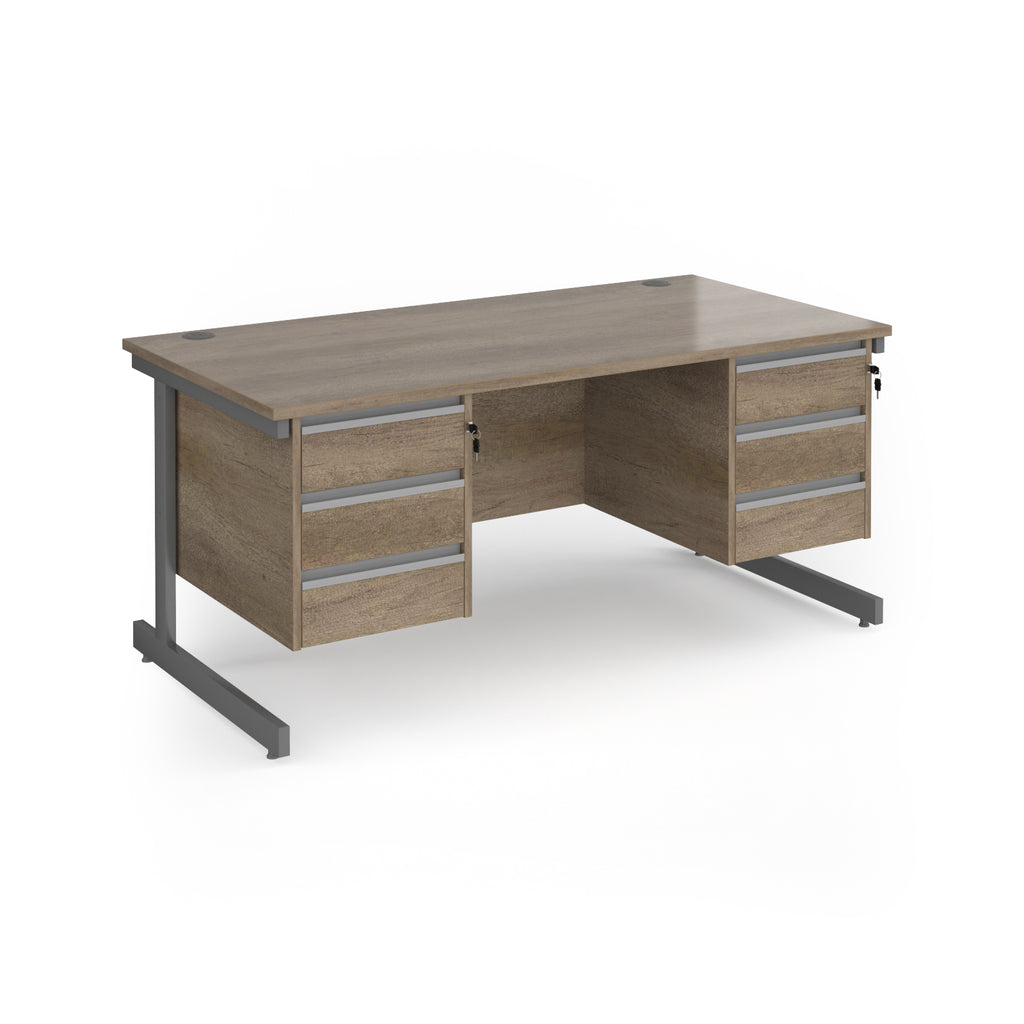 A modern office desk with a grey/brown wood grain finish and dark grey metal legs, featuring three drawers on the left and three drawers on the right.