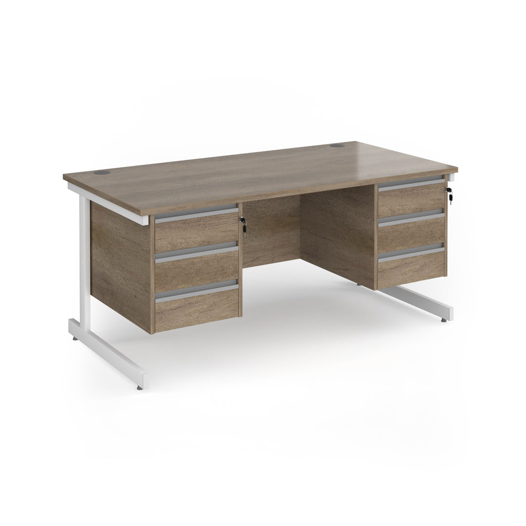 A modern office desk with a grey/brown wood grain finish and white metal legs, featuring three drawers on the left and three drawers on the right.