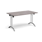 Folding table with grey wood-effect top and chrome legs on a white background