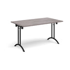 Folding table with grey wood-effect top and black legs on a white background