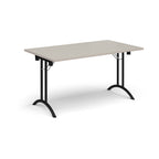 Folding table with light grey top and black legs on a white background