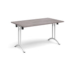 Folding table with grey wood-effect top and white legs on a white background