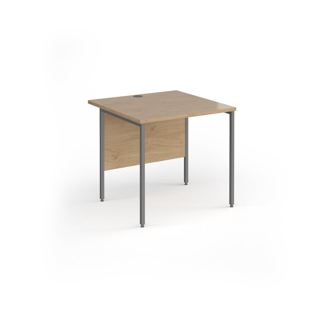 A square office desk with a wood-effect top and matching modesty panel, supported by slim grey metal legs, shown on a white background.