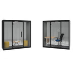Two modern glass office pods with black frames shown on a white background, one with yellow stools and one with a desk and chair.