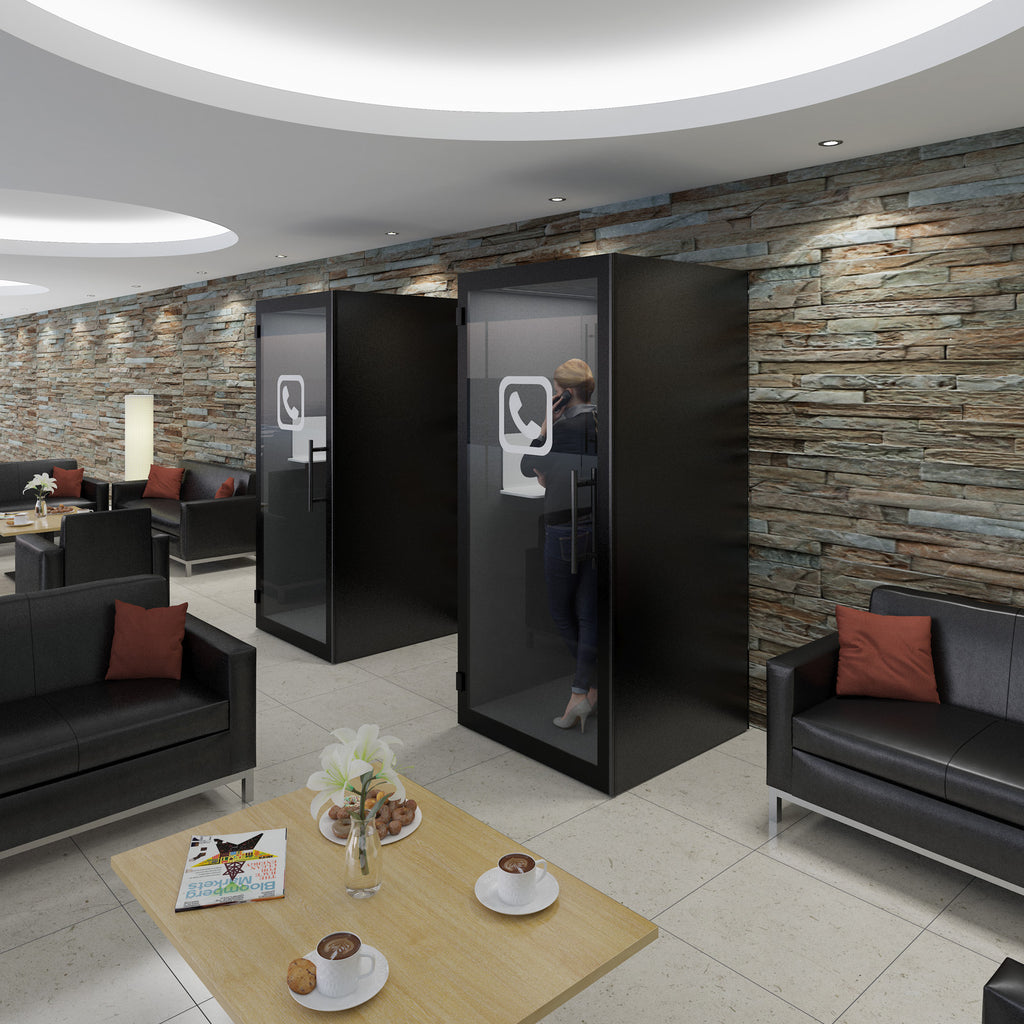 Modern waiting area with black privacy booths and comfortable seating.