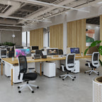 Modern office space with desks, chairs, and computer monitors.