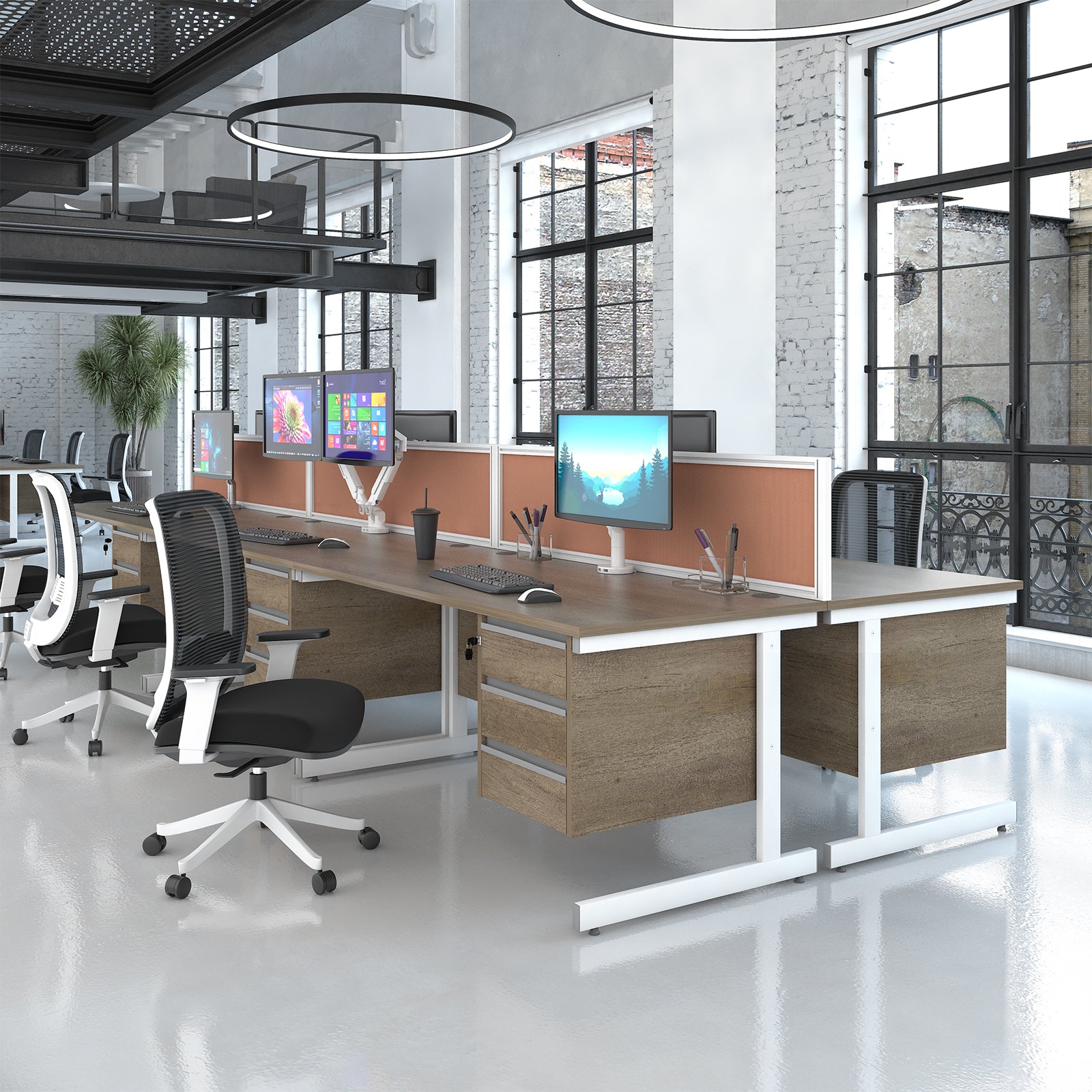 Modern office desk setup with dual wood-grain desktops, white metal frames, and orange-tinted dividers, shown in a bright office environment with office chairs and computer monitors.