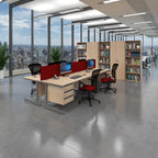 A modern office interior with a light wood desk setup, red privacy dividers, black and red office chairs, tall bookshelves, and large floor-to-ceiling windows overlooking a city skyline.