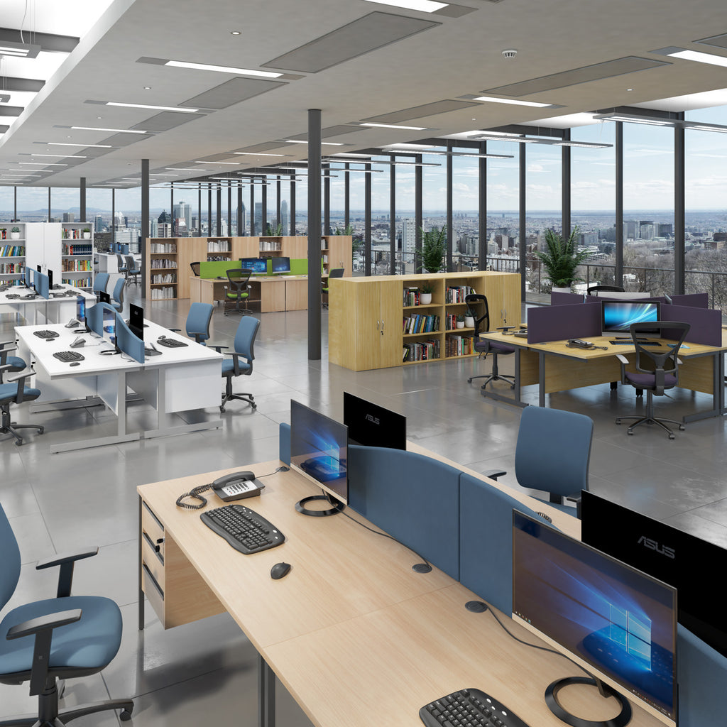 Modern office space with desks, chairs, and computer monitors.