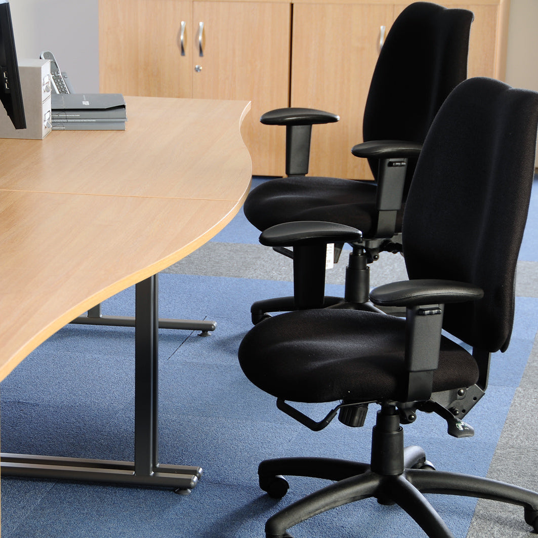 Office setup with a round wooden table and black office chairs.