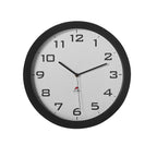 Wall clock with black frame and white face on a white background