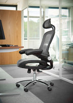 Ergonomic office chair in a modern office setting with large windows.