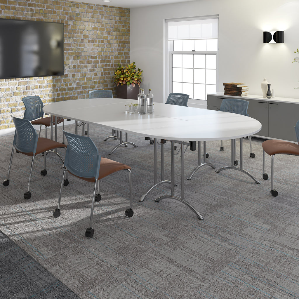 A modern conference room setup featuring a large oval white meeting table with chrome legs, surrounded by blue mesh swivel chairs with brown upholstered seats, set on a grey patterned carpet.