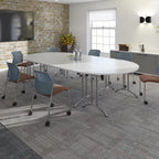 A modern conference room setup featuring a large oval white meeting table with chrome legs, surrounded by blue mesh swivel chairs with brown upholstered seats, set on a grey patterned carpet.