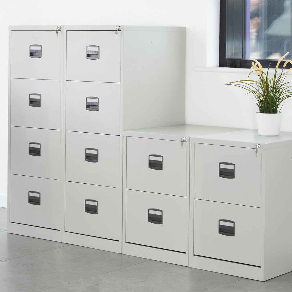 White filing cabinets with black handles in an office setting.