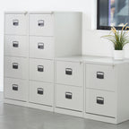 White filing cabinets with black handles in an office setting.