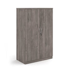A two-door cabinet with a grey wood grain finish, featuring two vertical doors with slim silver handles and small lock keys, shown on a plain white background.
