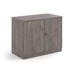 A two-door cabinet with a grey wood grain finish, featuring two vertical doors with slim silver handles and small lock keys, shown on a plain white background.