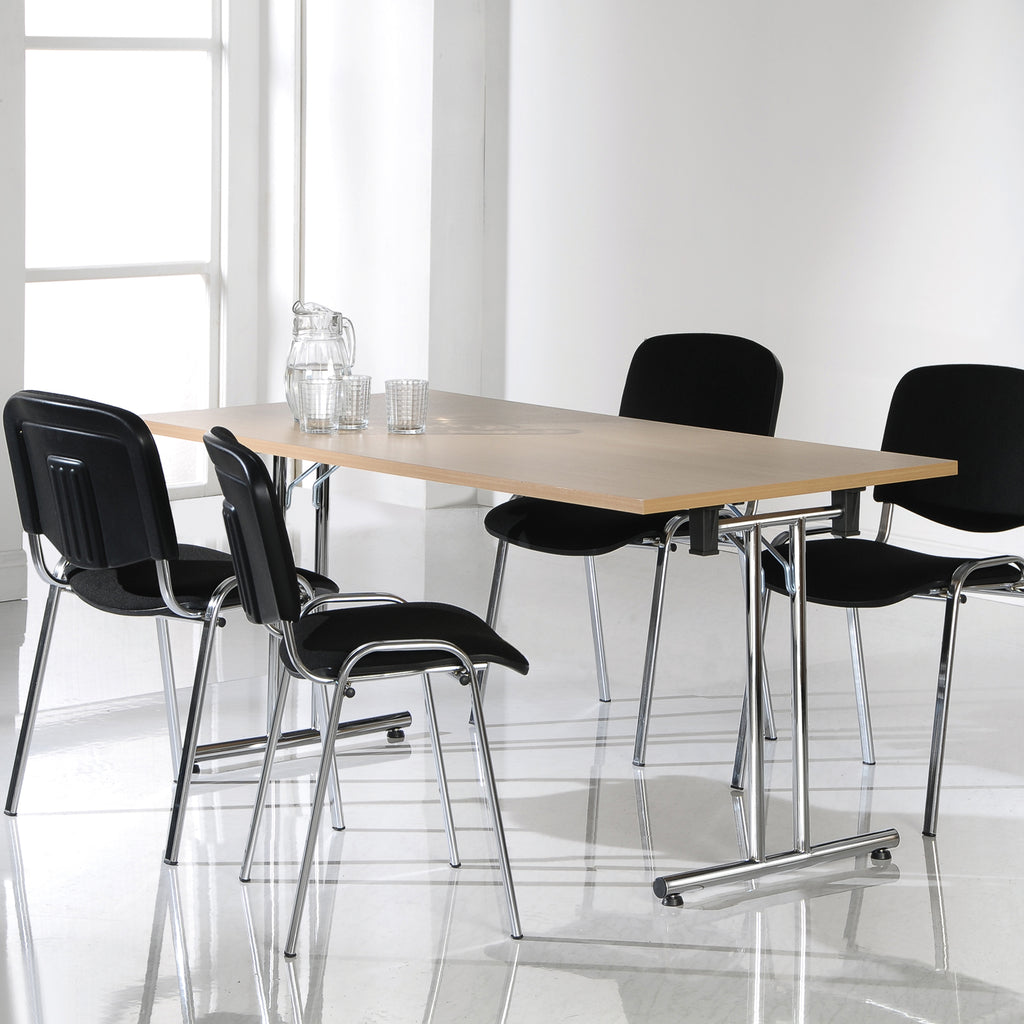 Modern conference table with black chairs in a bright room