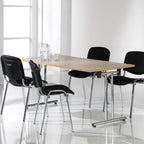 Modern conference table with black chairs in a bright room