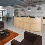 Modern office reception area with a wooden desk, chairs, and decorative elements.