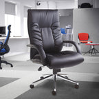 Black office chair in a modern office setting with other chairs in the background.