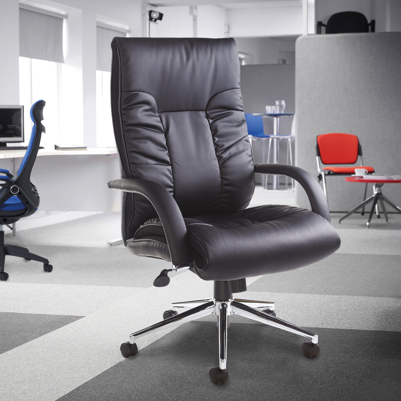 Black office chair in a modern office setting with other chairs in the background.