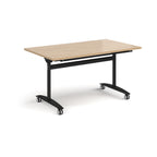 Rectangular table with a wood-effect top and black metal legs with castors on a white background