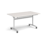 Rectangular table with a light grey top and silver metal legs with castors on a white background