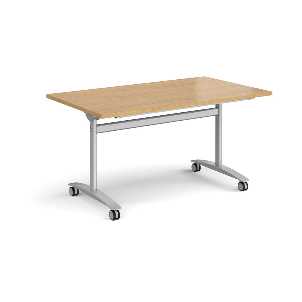Rectangular table with a wood-effect top and silver metal legs with castors on a white background