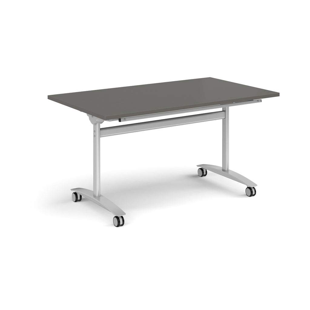 Rectangular table with a grey top and silver metal legs with castors on a white background