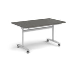 Rectangular table with a grey top and silver metal legs with castors on a white background