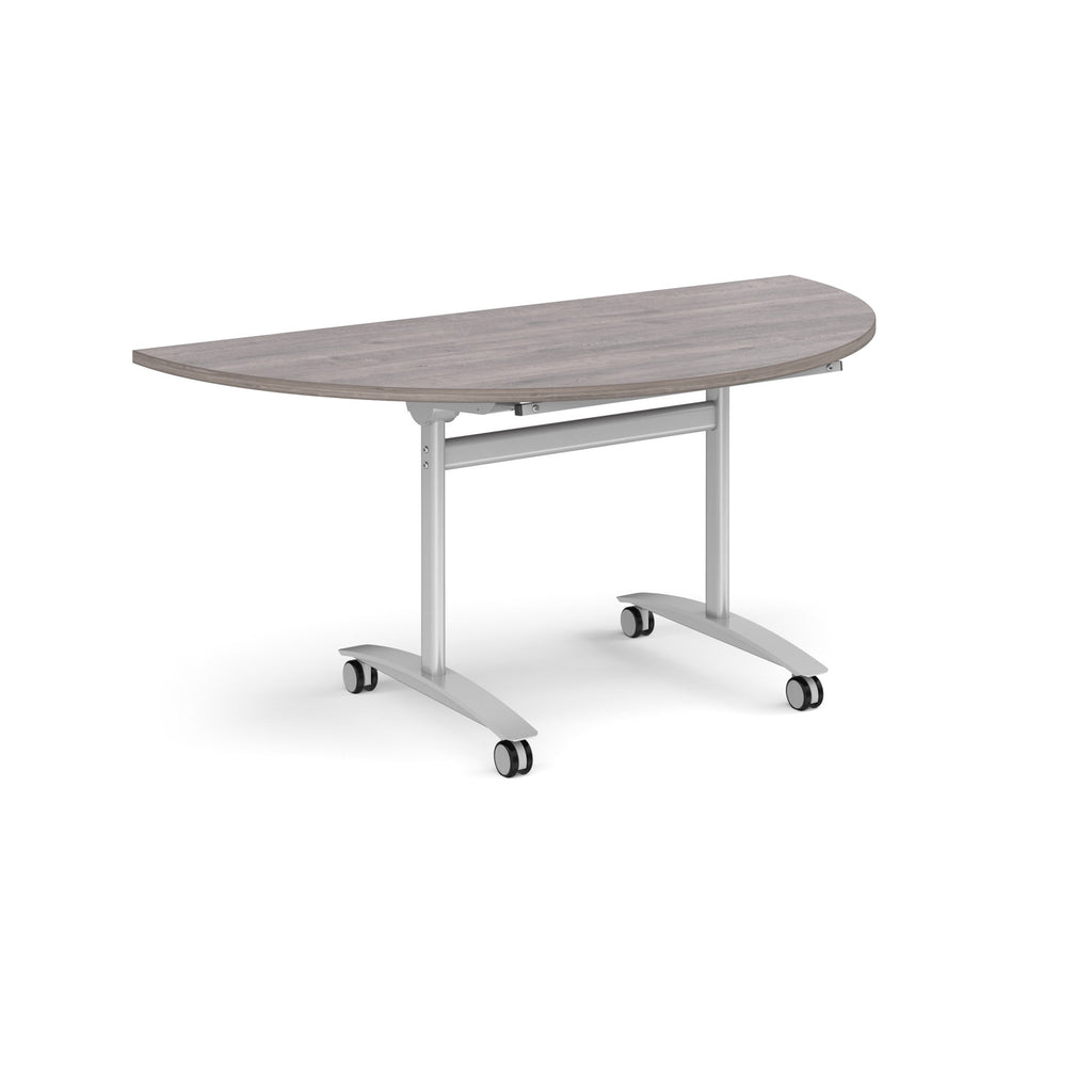 A semi-circular folding table with a grey wood-effect top and a silver metal frame on castors, shown on a plain white background.