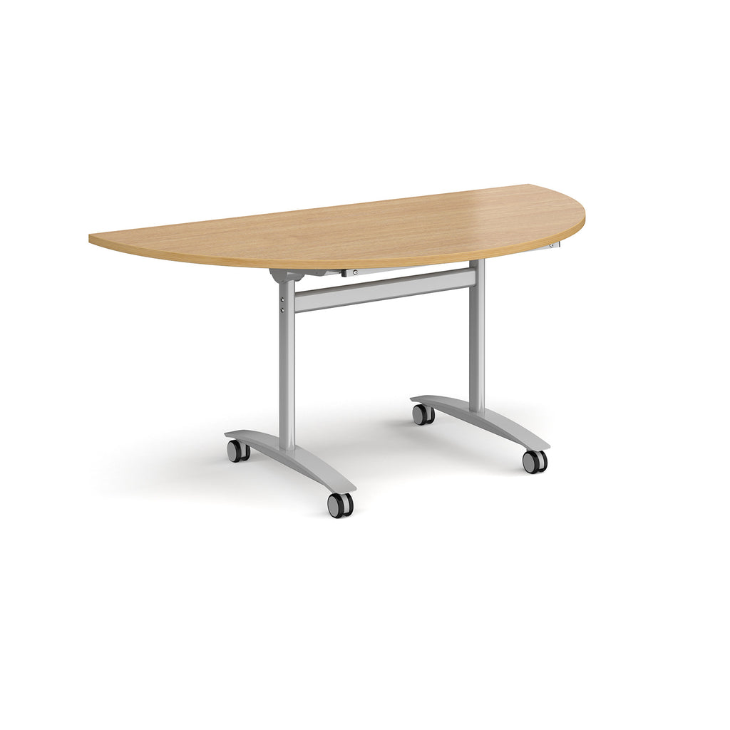 A semi-circular folding table with a wood-effect top and a silver metal frame on castors, shown on a plain white background.