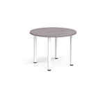 Round table with grey top and white legs on a white background