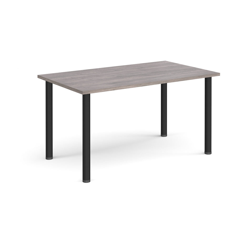 Rectangular table with a grey wood-effect top and black legs on a white background