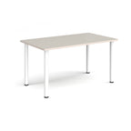 Rectangular table with light grey top and white legs on a white background