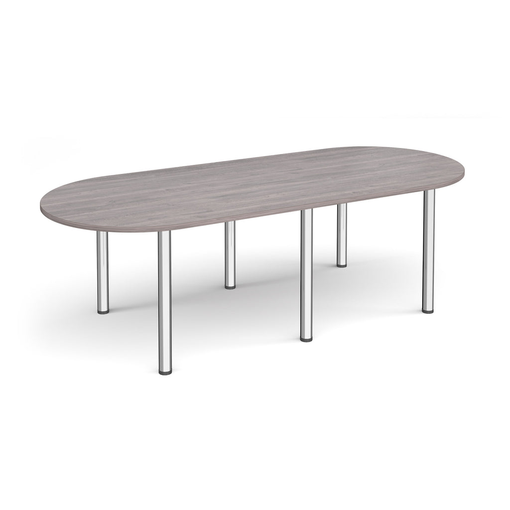 Oval table with grey wood-effect top and chrome metal legs on a white background