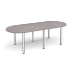 Oval table with grey wood-effect top and chrome metal legs on a white background