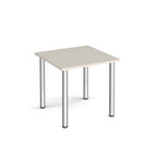 Square table with light grey top and metal legs on a white background