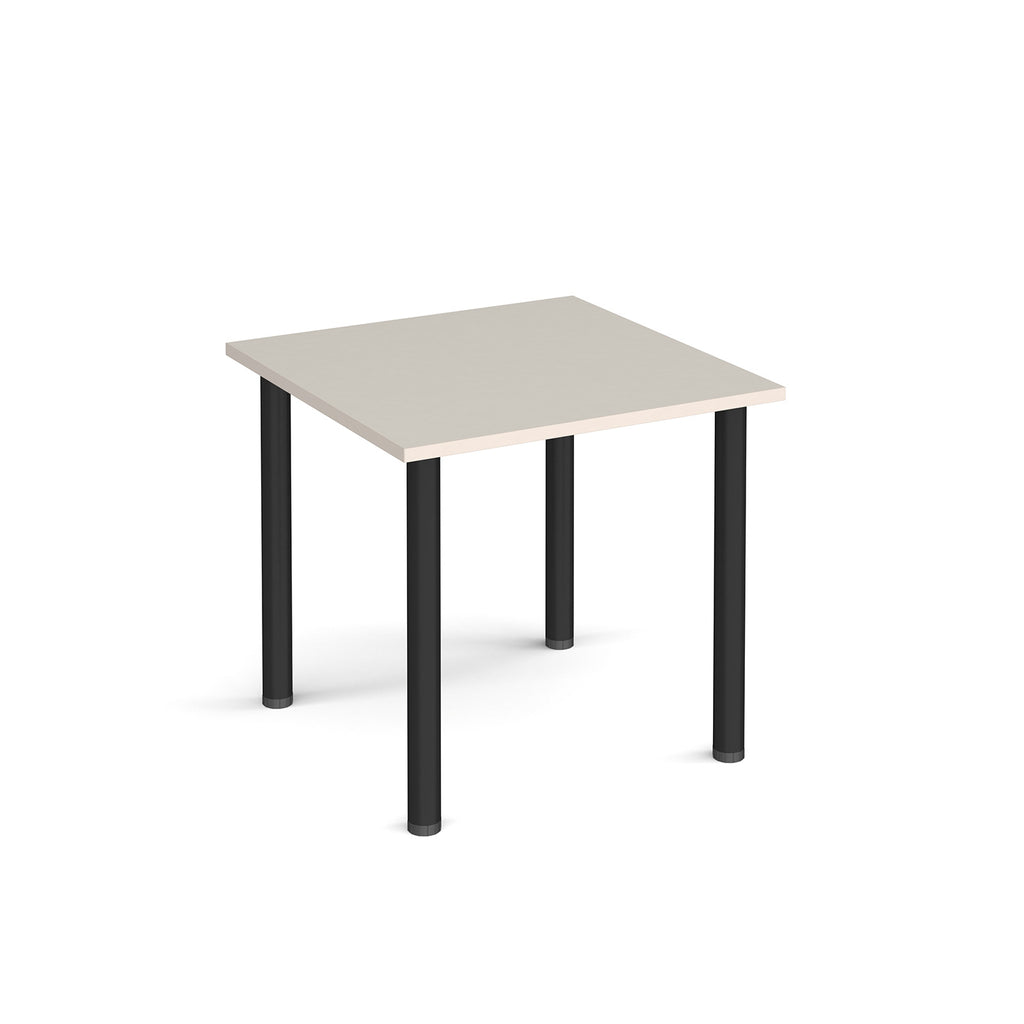 Square table with a light grey top and black legs on a white background